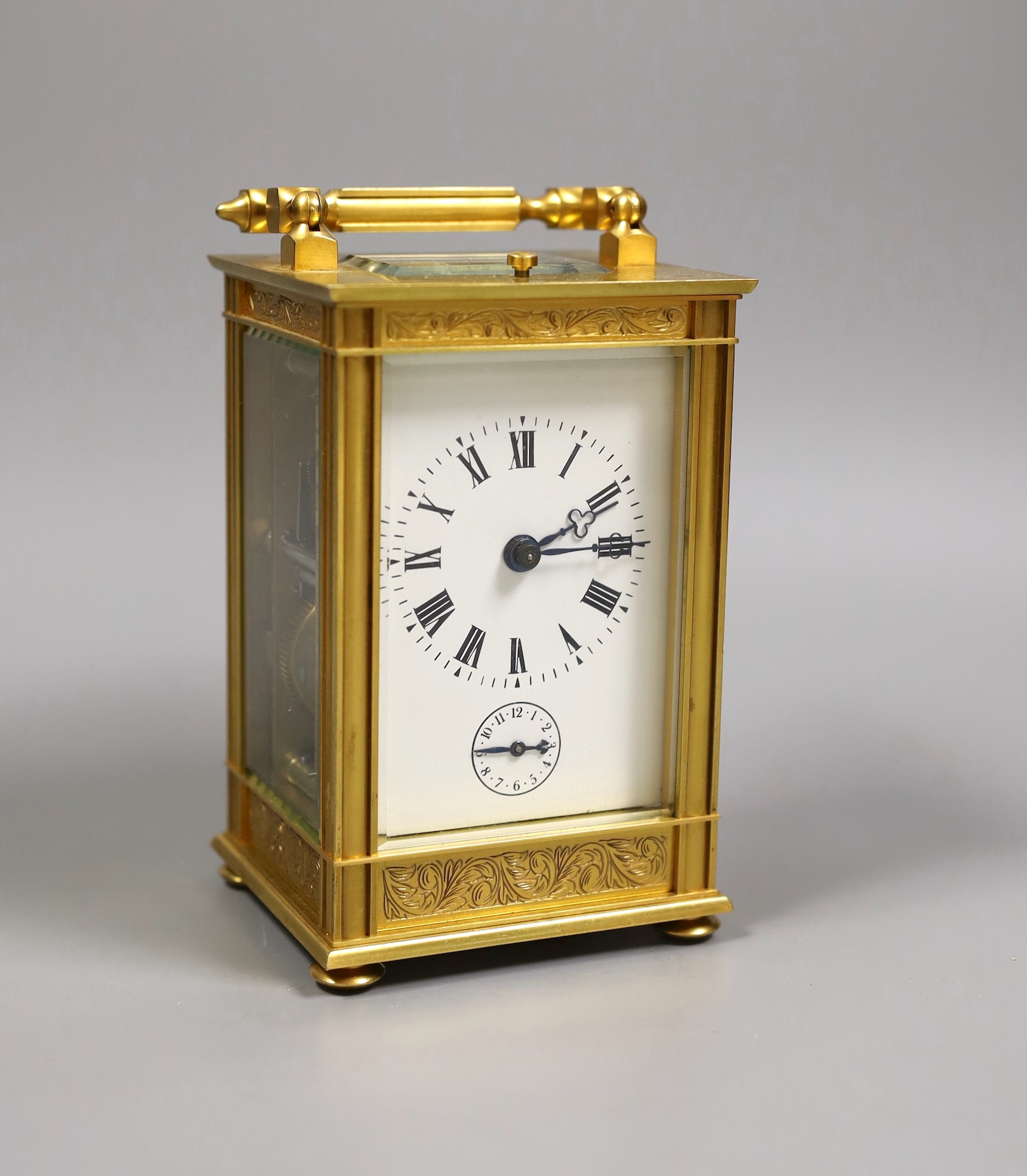 A French repeating carriage clock with alarm and with inlaid scroll decoration, with key, 19cm tall